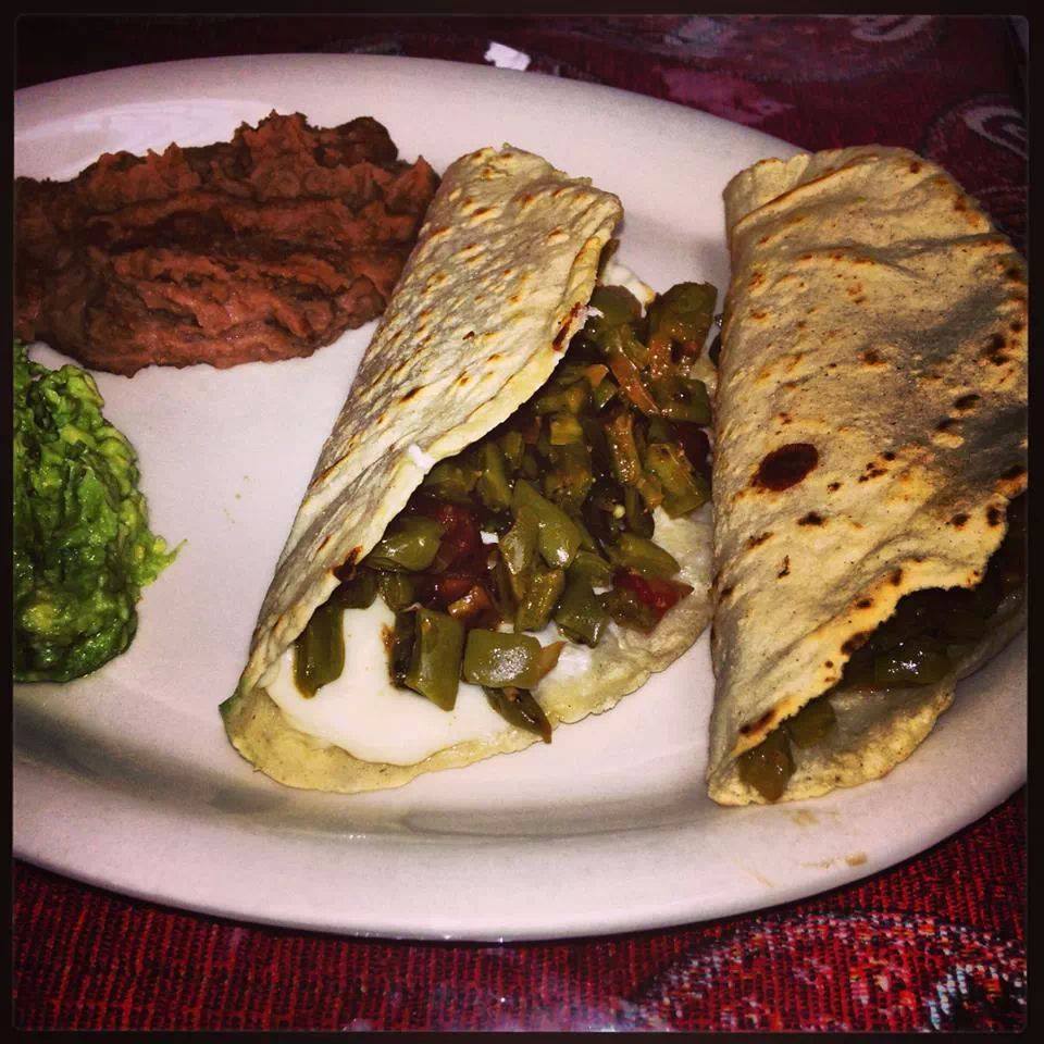Green chile tacos with refried beans and guacamole at Lucy Cafe